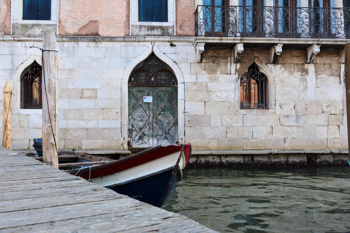 Boat moored in central Venice in front of ancient palace