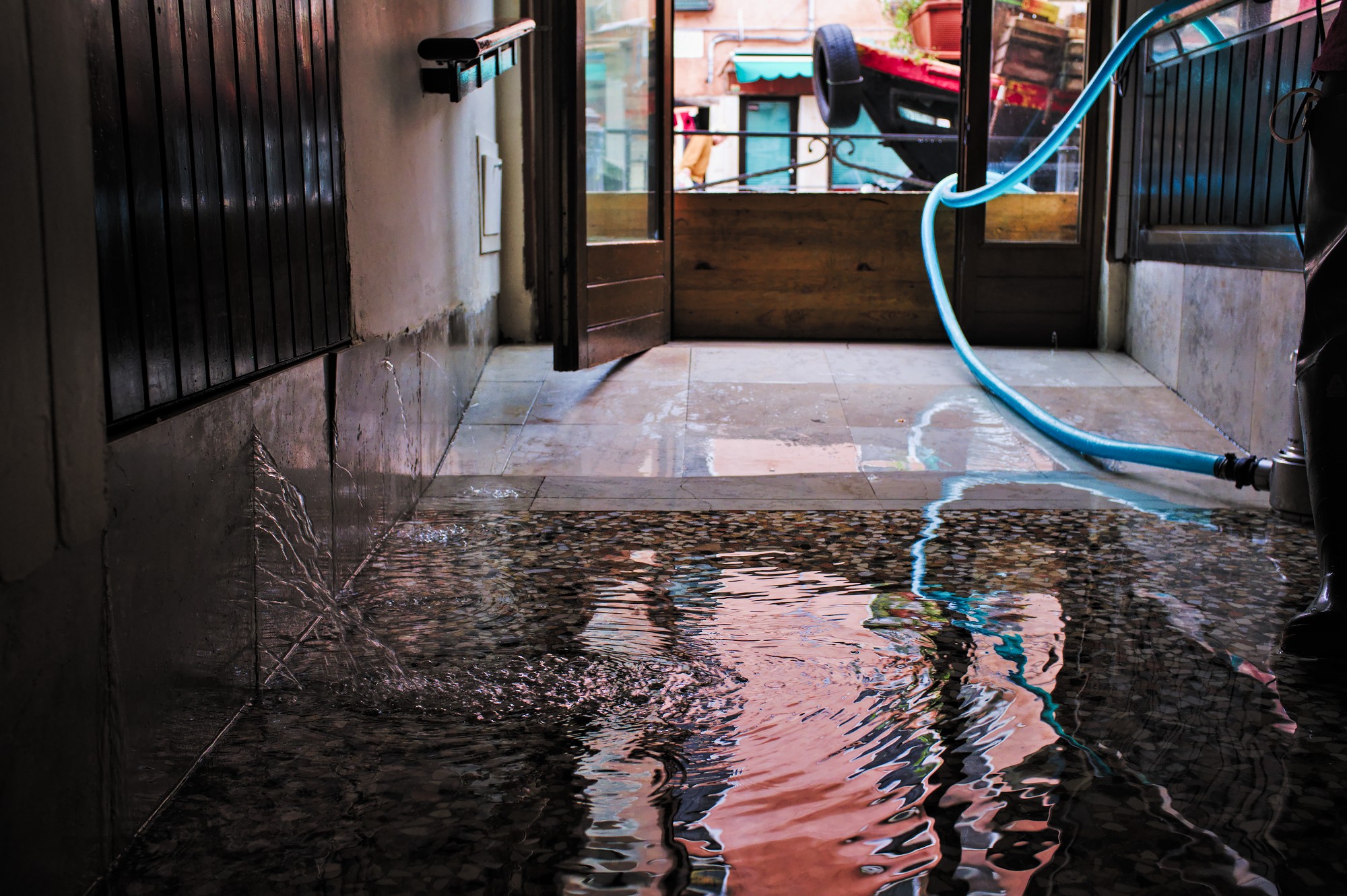 High tide in Venice - water entering throug the ancient walls