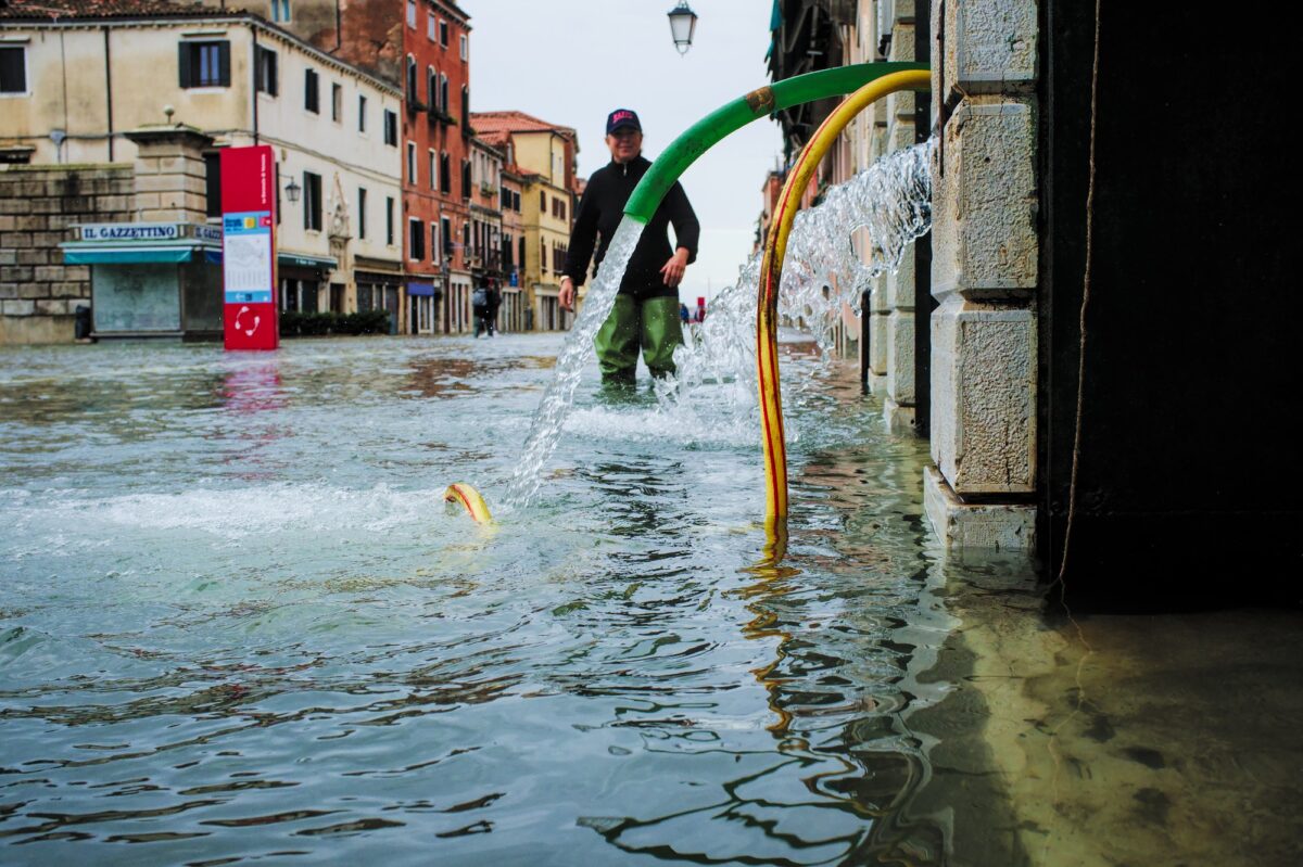 High tide in Venice - bar owner trying to fight the tide