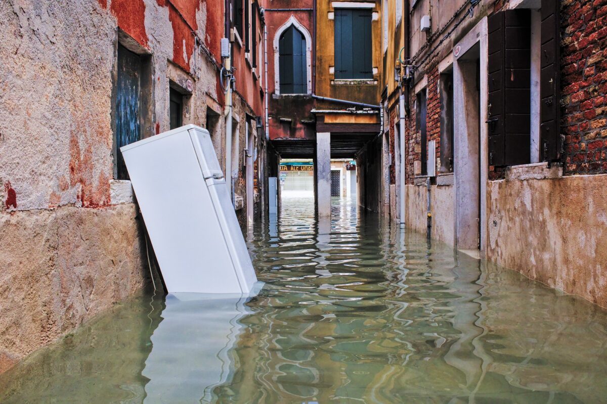 High tide in Venice - ruined fridge waiting for the garbage collectors
