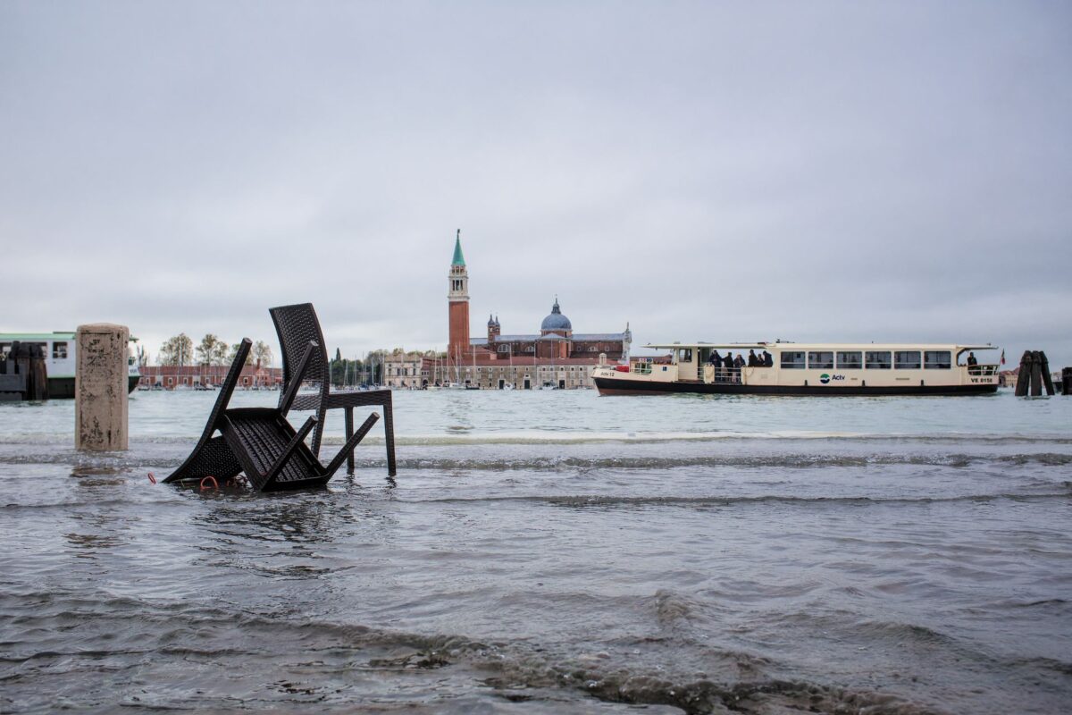 Abandoned chairs on the quayside- High tide in Venice