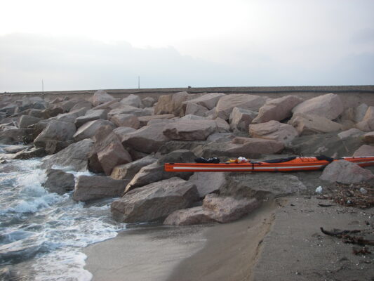The kayaks tne morning after - the sea has eaten more than a metre of the beach