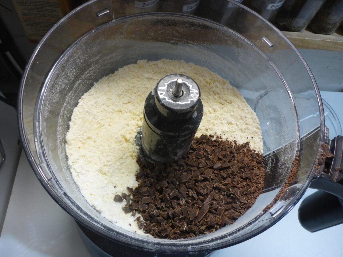 Photo of the mixture in the food processor with chocolate added.