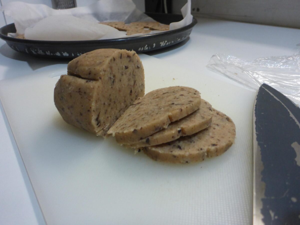Photo of the cookie dough roll being cut into slices